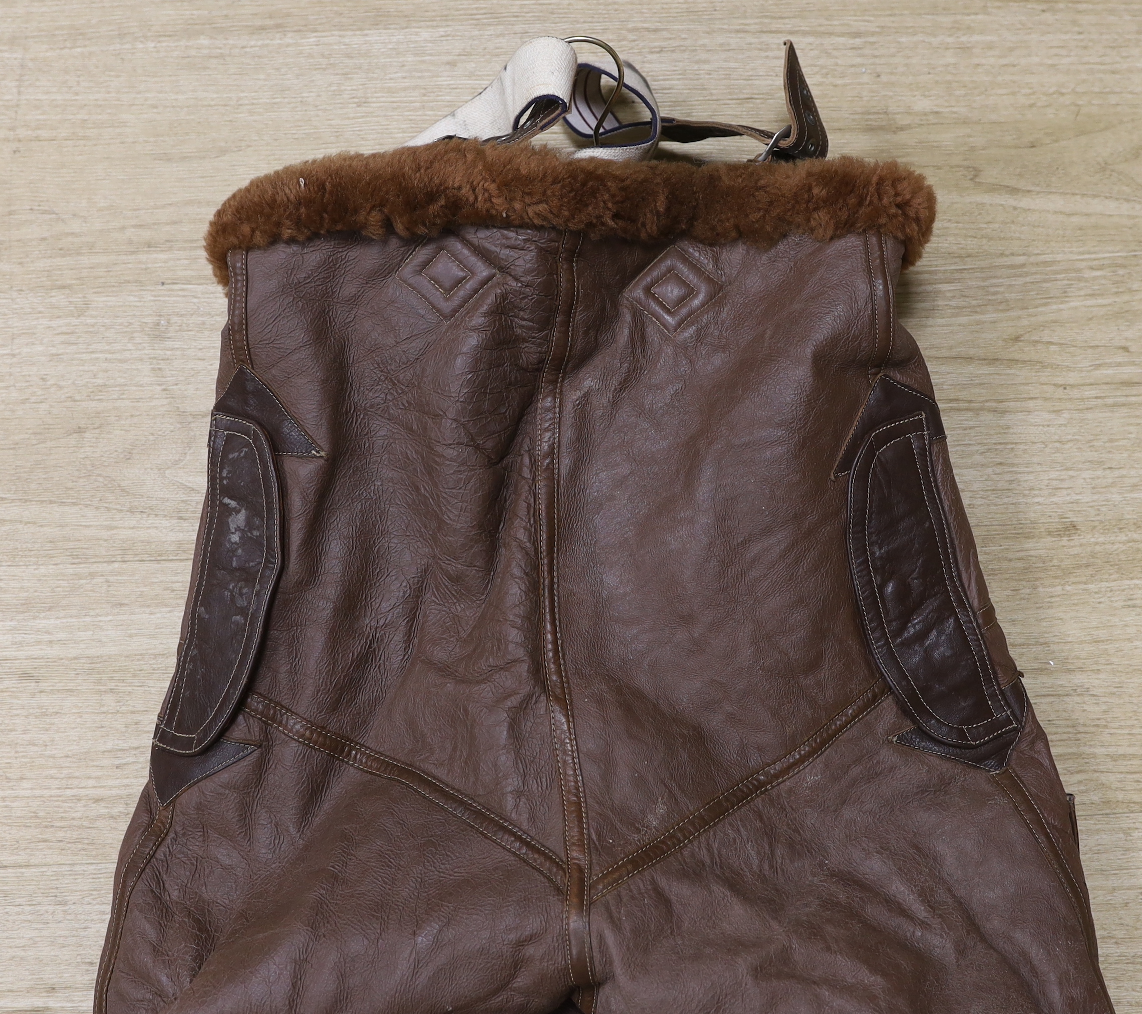 A pair of WWII Air Ministry issue RAF sheepskin breeches, with original label stating; ‘AM, Size: 5, Waist: 34-36, Seat: 40-42, Leg:32.5, 539778’, added in pen; ‘Brown’, provenance - by family descent